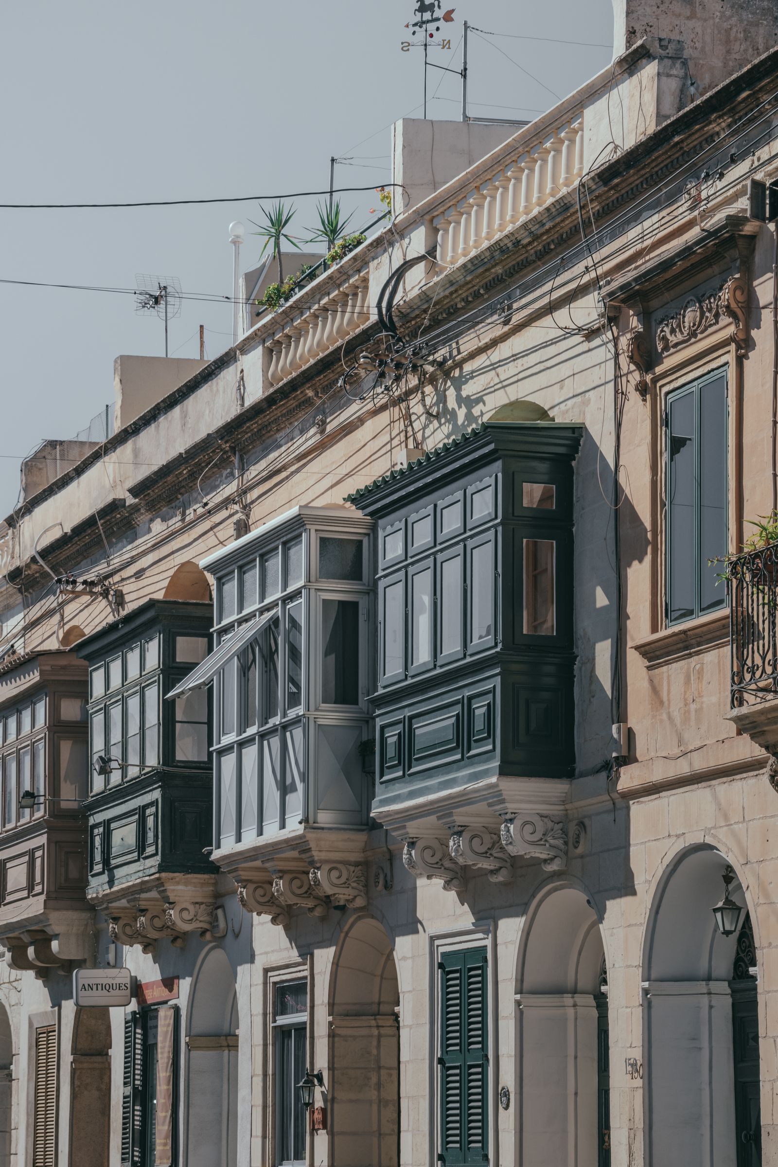 Traditional Maltese wooden balconies on limestone facades