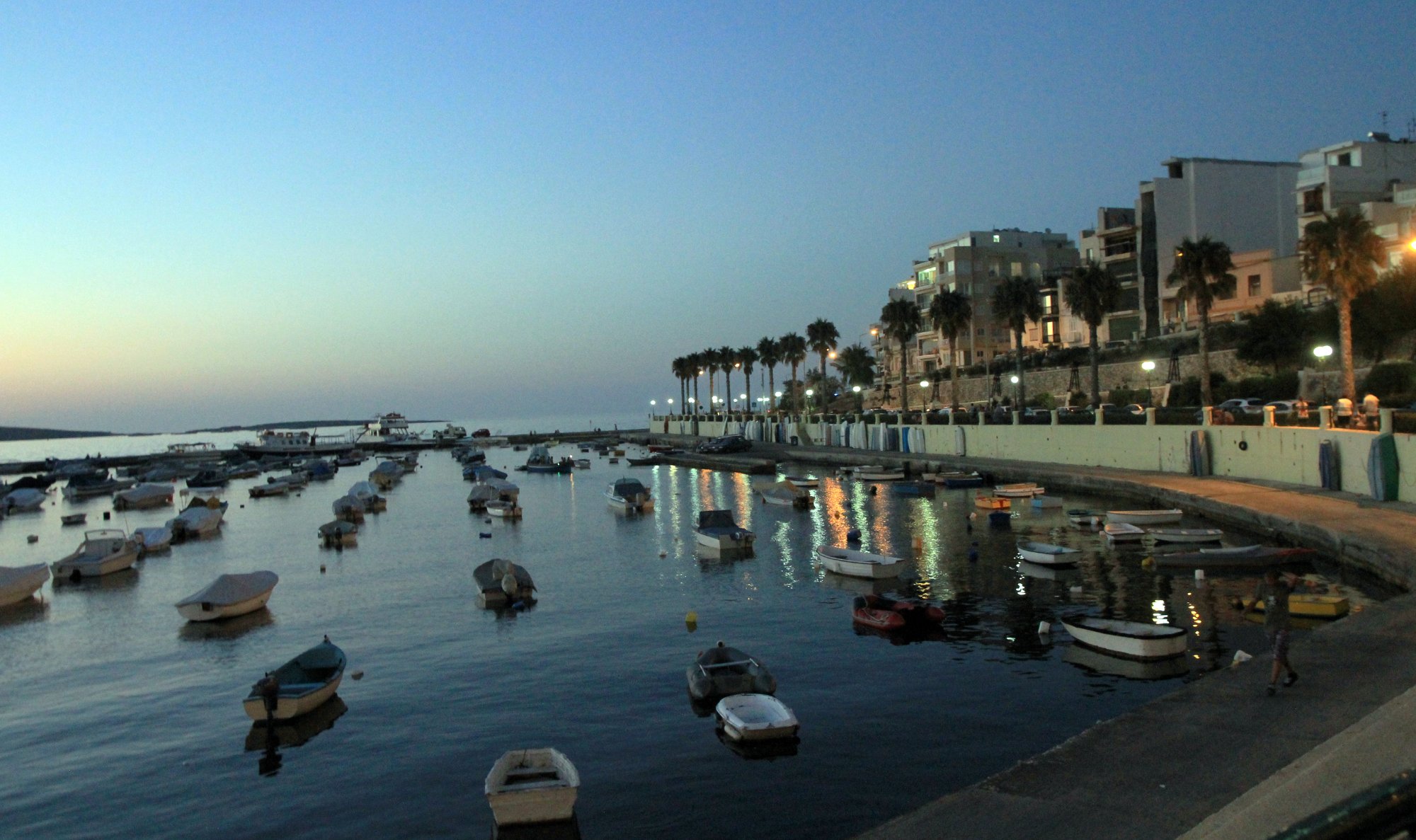 Fishing boats in Buġibba harbour at sunset